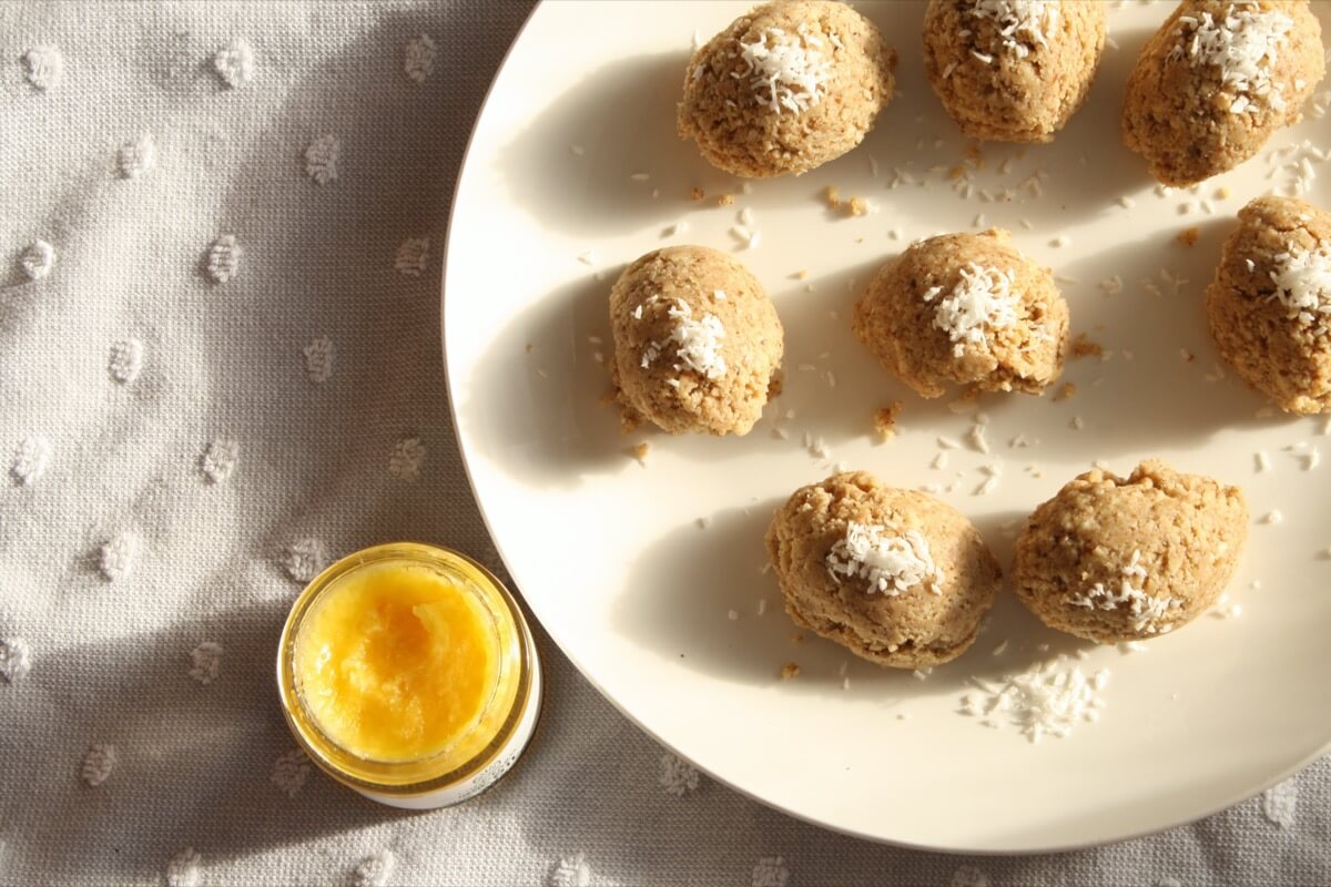 Plate of coconut bliss balls with jar of hemp coconut oil